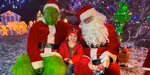 Santa and Grinch handing out Candy Canes