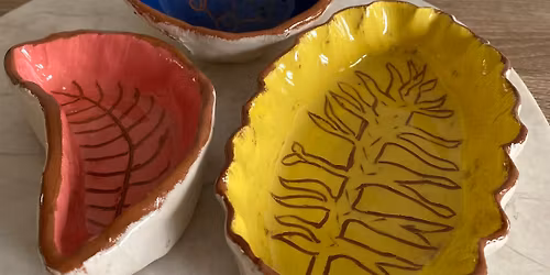 Hand-built ceramic bowl with slip decoration.